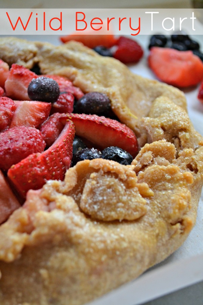 Wild Berry Tart recipe, a mix of fresh and sweetened raspberries, blueberries, and strawberries enveloped in a pie crust.