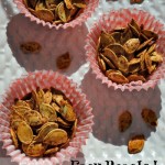 easy roasted pumpkin seeds, seeds in cupcake liners on white plate with seeds scattered